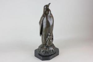 ANONYMOUS,Penguin with chick standing on a Christmas pudding,Henry Adams GB 2015-12-03