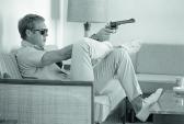 Dominis John 1921-2013,Steve McQueen aims a pistol in his living room, Pa,2013,Osenat FR 2013-10-20